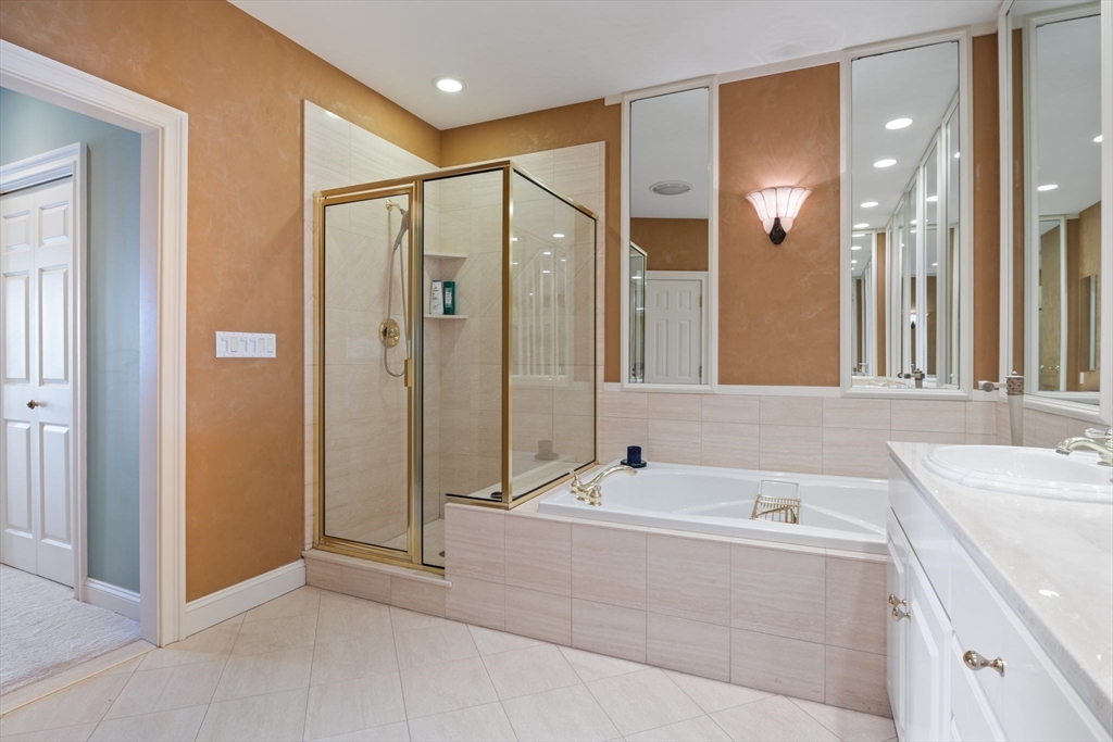163 Little Harbor Road, Unit 163 New Castle, NH 03854 - Photo 28 of 36 a bathroom with a tub sink shower and mirror