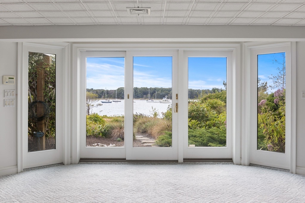 163 Little Harbor Road, Unit 163 New Castle, NH 03854 - Photo 29 of 36 a view of a big room with windows and yard