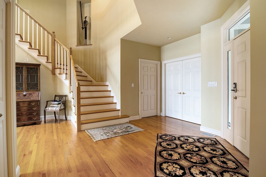 163 Little Harbor Road, Unit 163 New Castle, NH 03854 - Photo 5 of 36 a view of a hallway with wooden floor and staircase