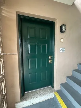 an empty room with windows and entrance