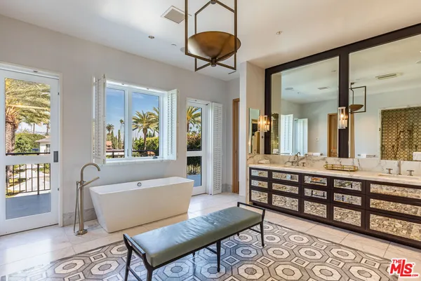a living room with furniture a rug and a chandelier