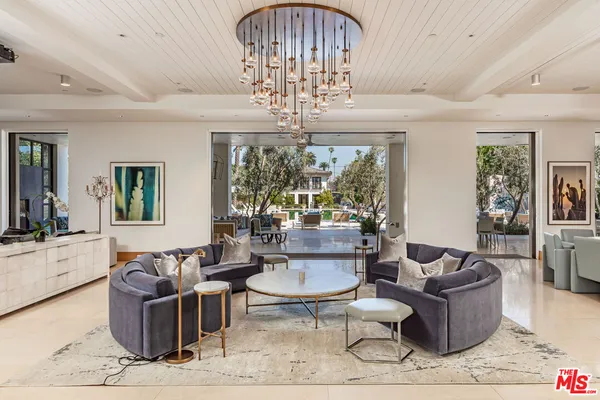 a living room with furniture a chandelier and a chandelier
