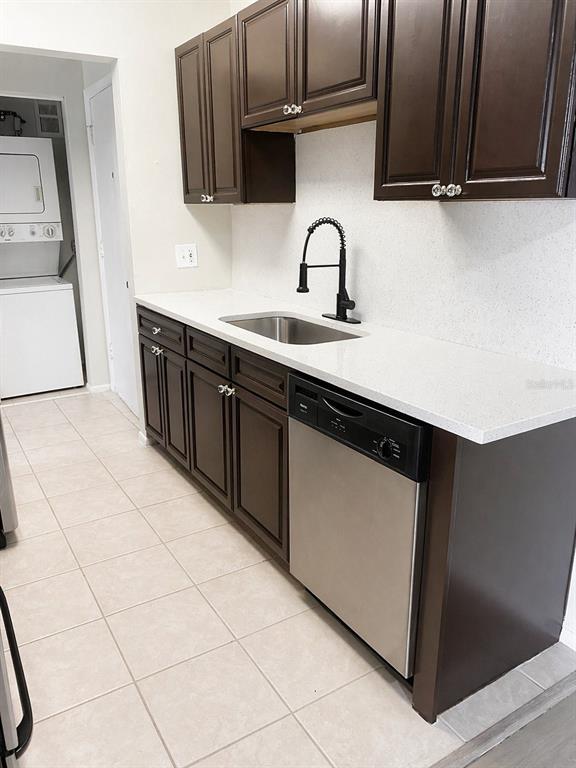 1695 Lee Road, Unit C206 Winter Park, FL 32789 - Photo 5 of 18 a kitchen with a sink a stove and cabinets