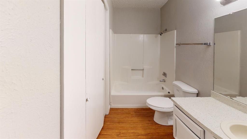 9696 Walnut Street, Unit 1203 Dallas, TX 75243 - Photo 5 of 6 a bathroom with a toilet a sink and a bathtub