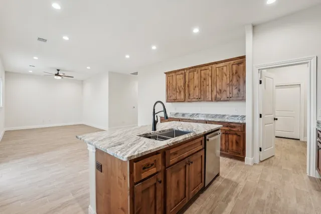 a kitchen that has a sink and a stove in it