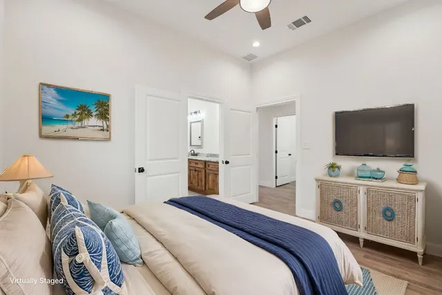 a bedroom with a bed and a flat screen tv