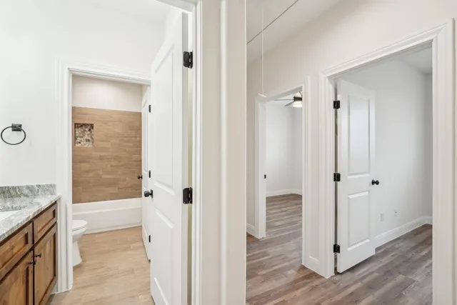 a bathroom with a granite countertop tub shower and a sink