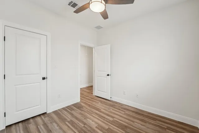 a view of a room with wooden floor