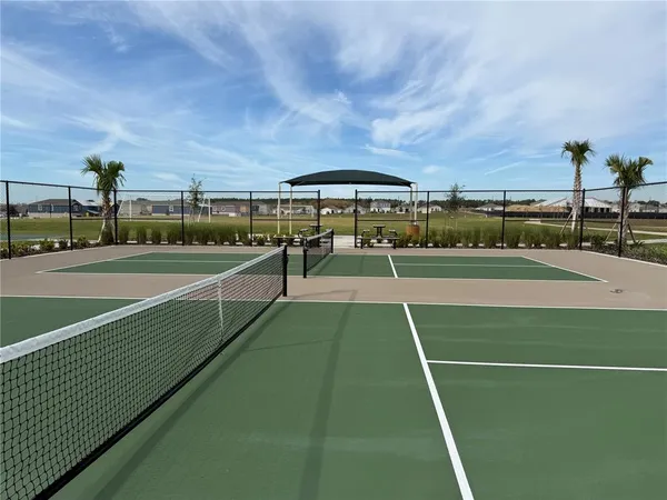 a view of an outdoor space and tennis court