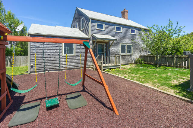 33 Bartlett Road Nantucket, MA 02554 - Photo 24 of 29 a front view of a house with garden and sitting area