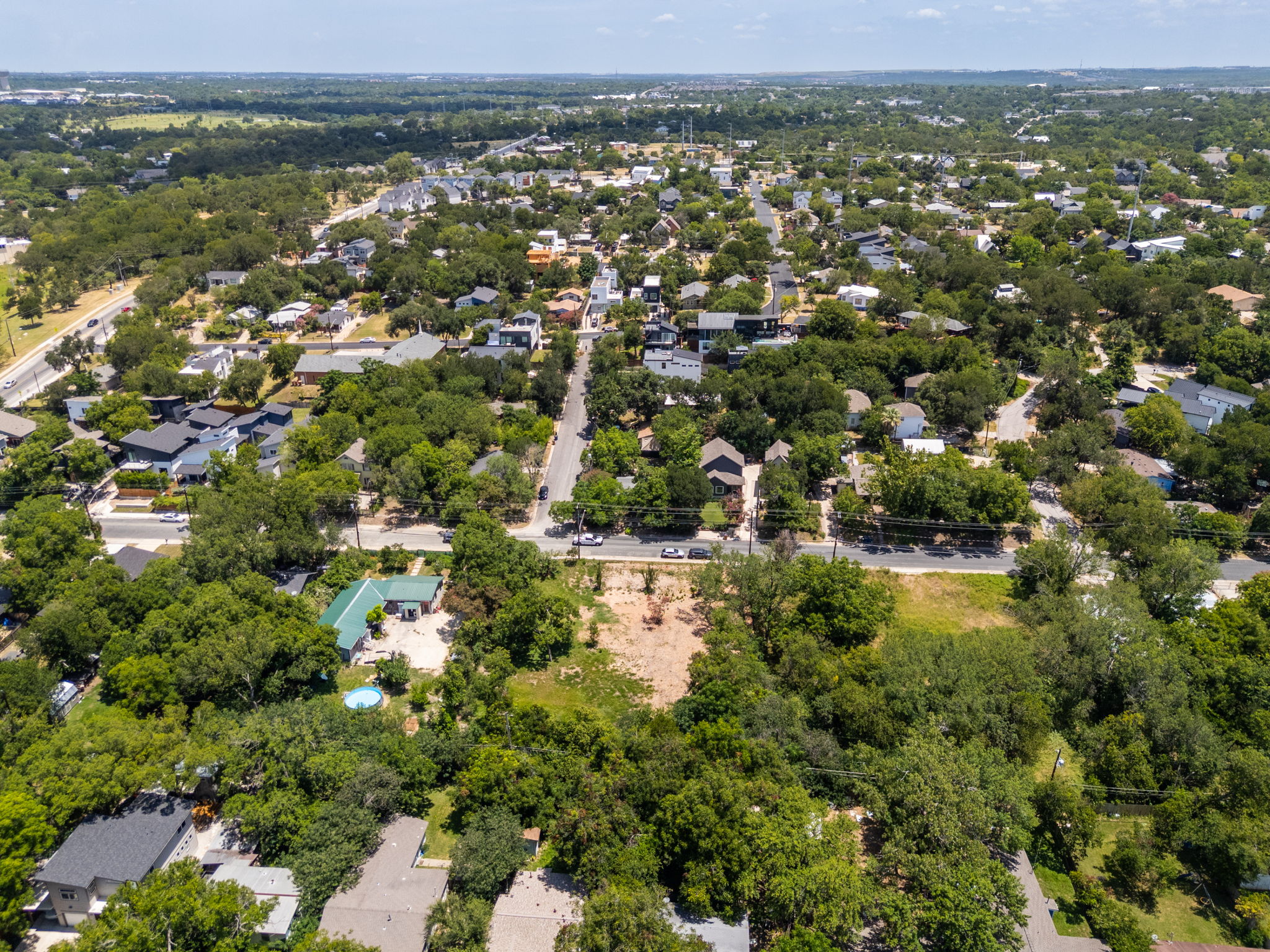 4801 Ledesma Road Austin, TX 78721 - Photo 16 of 24 An aerial perspective reveals a verdant neighborhood with established trees and residential properties.