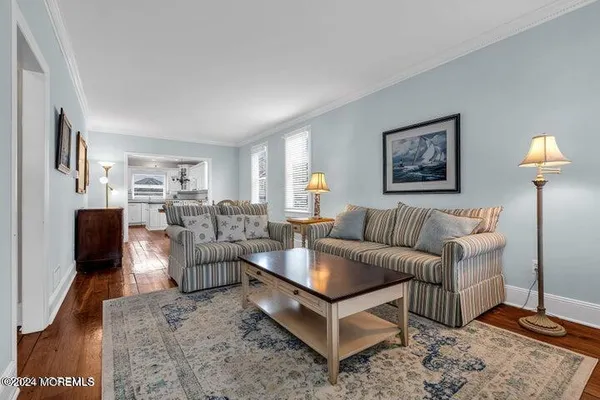 a living room with furniture a lamp and a flat screen tv