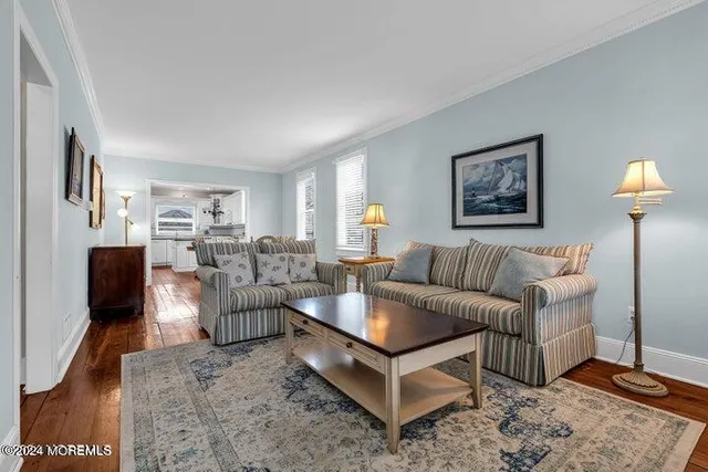 a living room with furniture a lamp and a flat screen tv