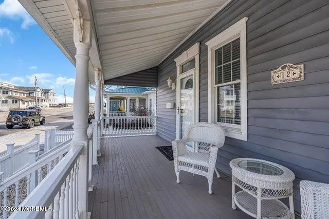 a balcony with table and chairs