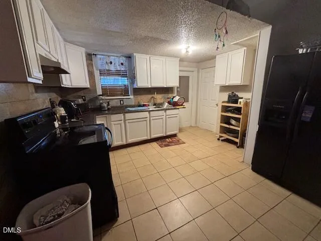 a kitchen with a sink a stove and cabinets