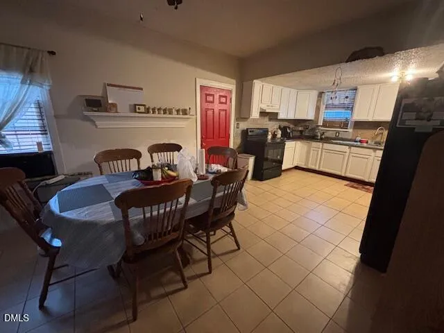 a kitchen with granite countertop cabinets a dining table and chairs