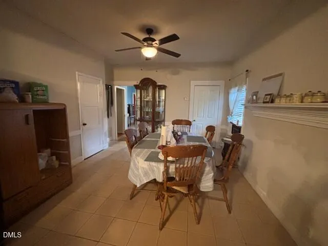 a view of a dining room with furniture and a chandelier