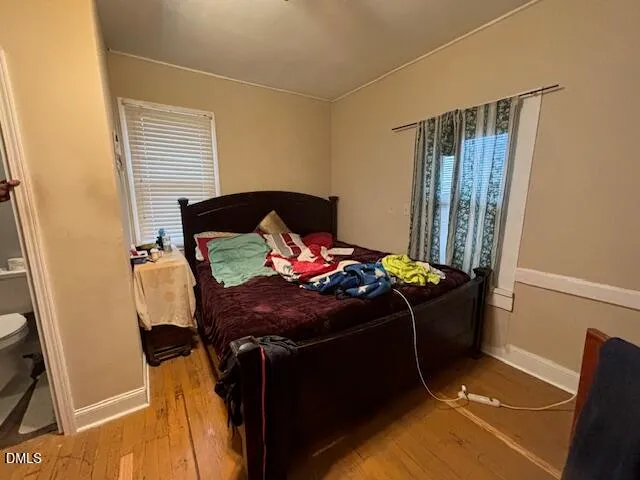 a bed sitting in a bedroom next to a window