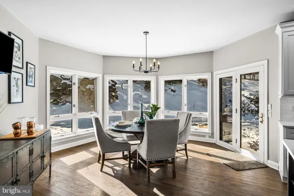 a view of a dining room with furniture window and wooden floor
