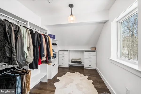 a spacious bedroom with a bed and a couch