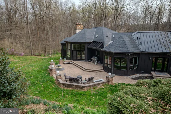 a kitchen with stainless steel appliances a dining table chairs stove refrigerator and cabinets