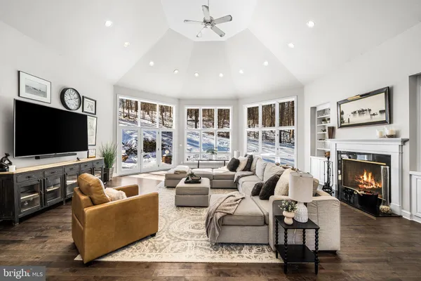 a living room with furniture fireplace and flat screen tv
