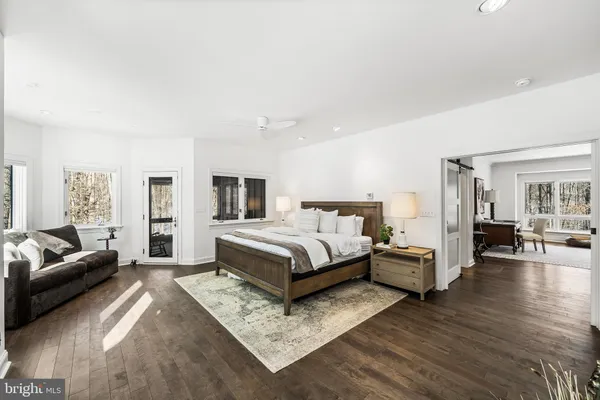 a spacious bedroom with a bed a couch and a couch