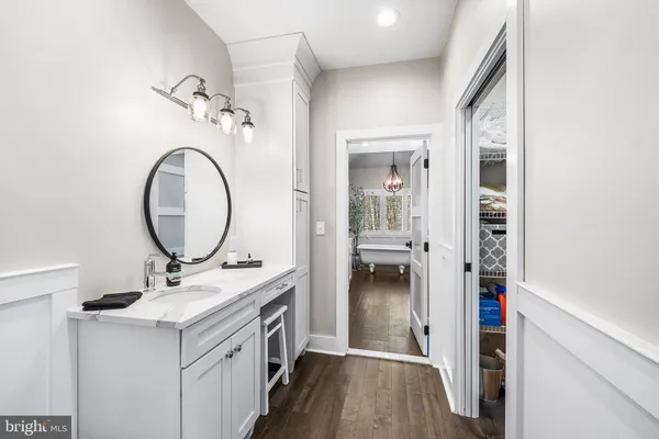 a bathroom with a sink vanity and a mirror