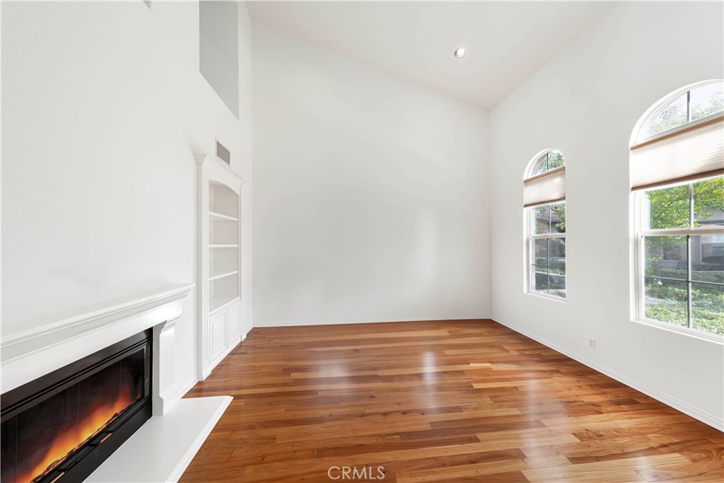 51 Mandria Newport Coast, CA 92657 - Photo 4 of 32 Living room with lots of natural light, high ceiling and fireplace