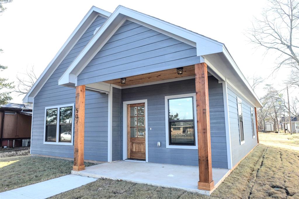 a front view of house with a garden