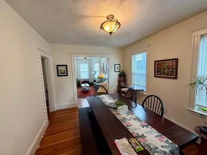 a view of a livingroom with furniture window and wooden floor