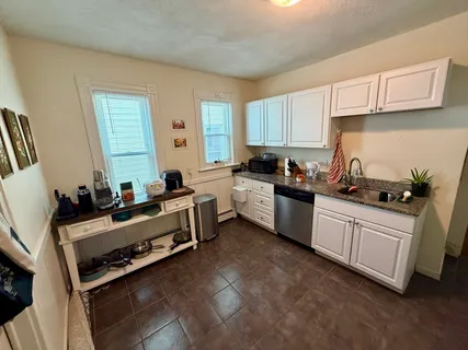 a kitchen with stainless steel appliances a stove a sink a refrigerator and cabinets