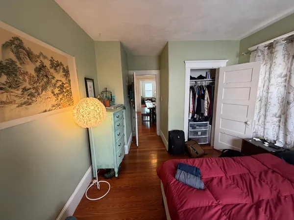 a bedroom with a bed and a mirror