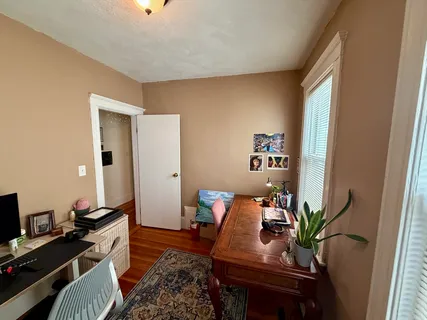 a work room with furniture and wooden floor