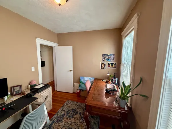 a work room with furniture and wooden floor