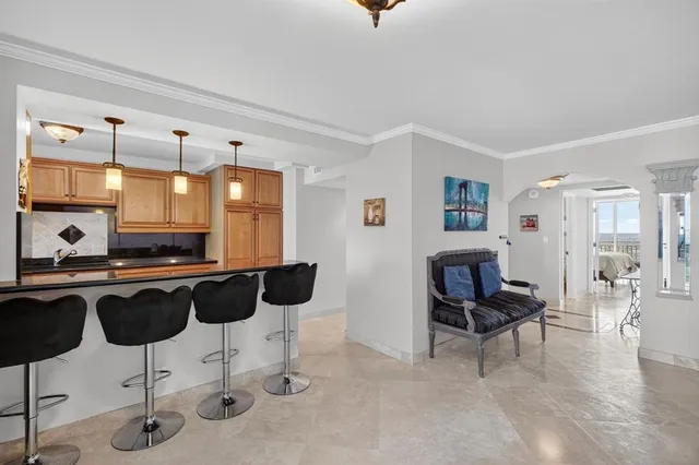 a kitchen with stainless steel appliances kitchen island granite countertop a refrigerator and a stove top oven