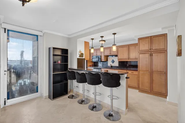 a kitchen with stainless steel appliances a sink stove and refrigerator