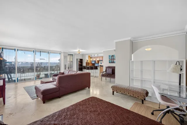 a living room with furniture and a glass door