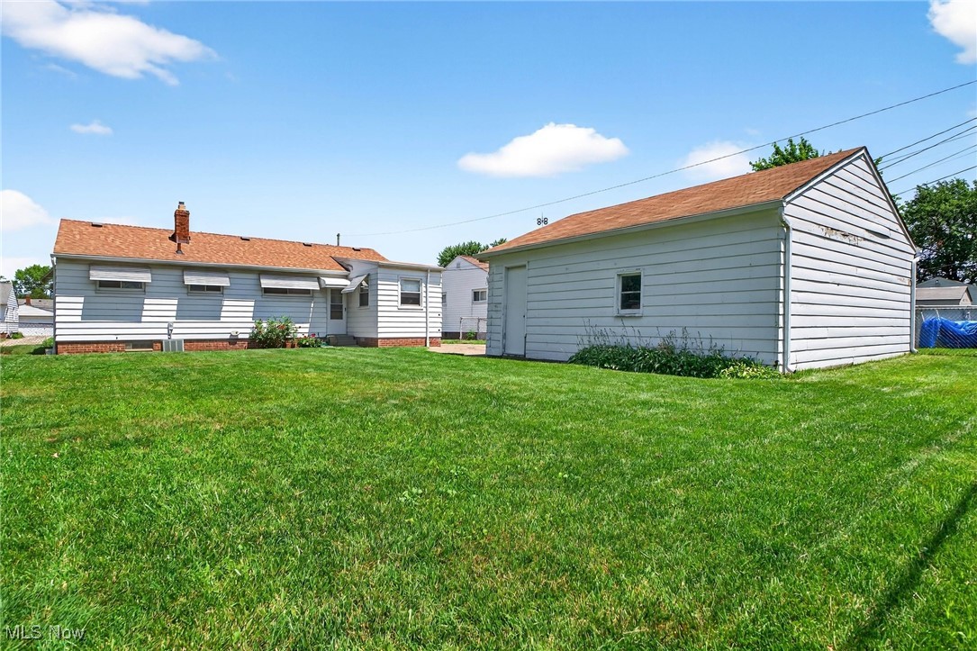 30112 Barjode Road Willowick, OH 44095 - Photo 6 of 28 Back of house featuring a lawn and a chimney