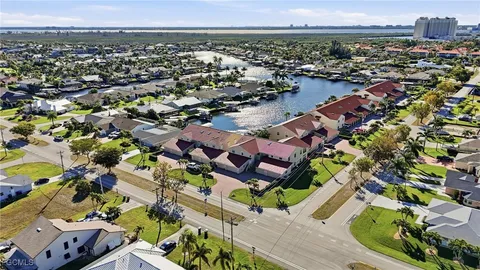 a aerial view of a house with a yard and sitting area