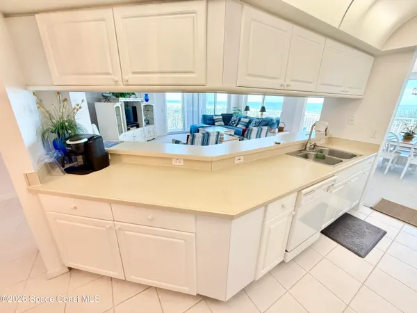 a kitchen with sink cabinets and appliances