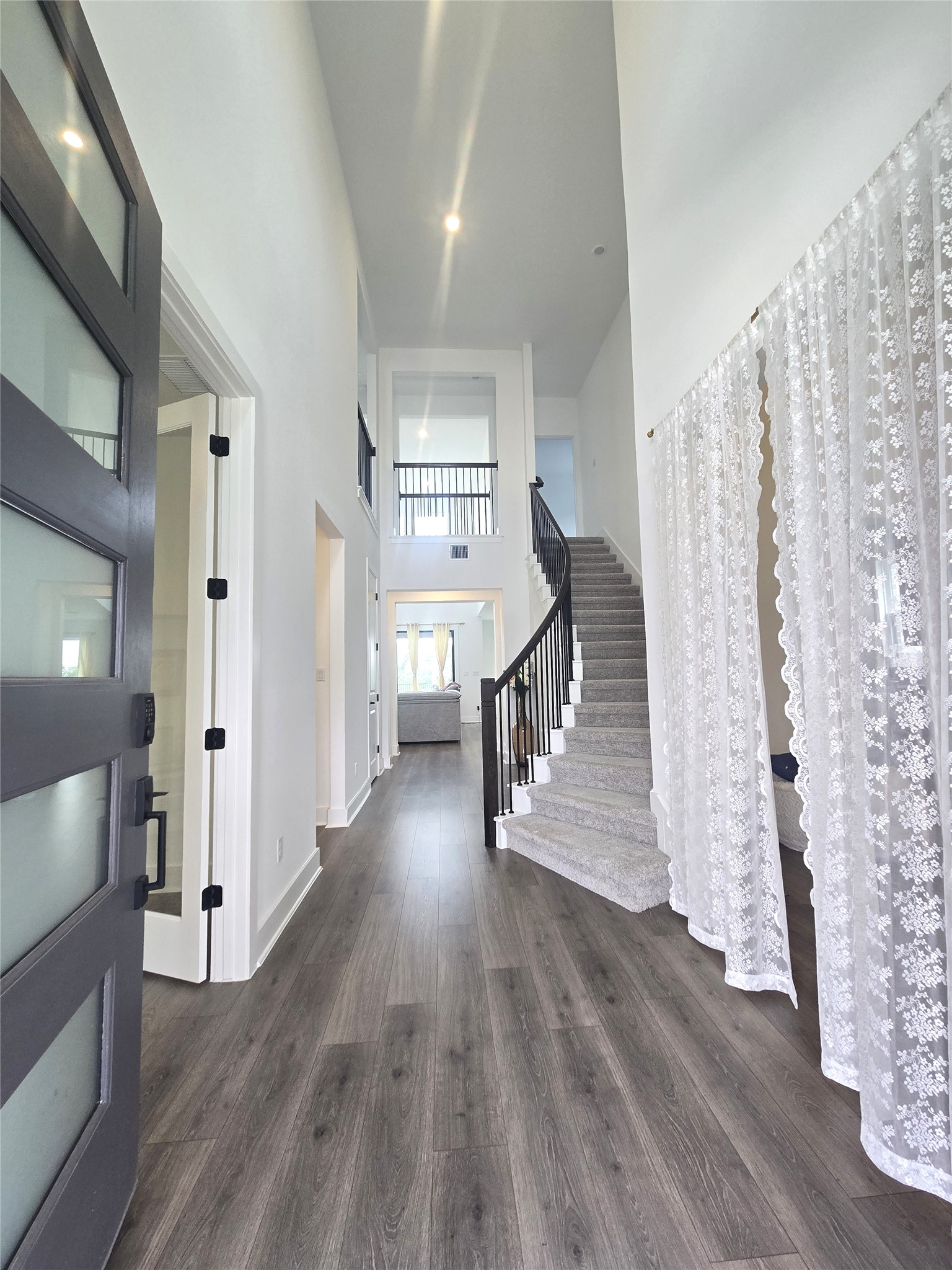 124 Ribera Drive Liberty Hill, TX 78642 - Photo 5 of 40 A grand entry showcases soaring ceilings, a sweeping staircase, and resilient flooring.
