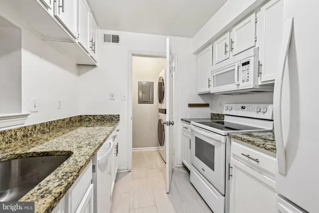 a kitchen with stainless steel appliances granite countertop a stove and a refrigerator