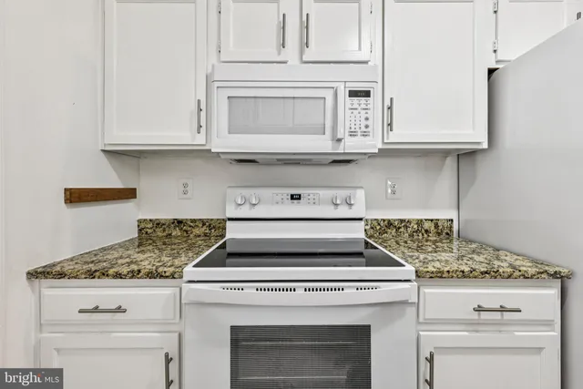 a stove top oven sitting inside of a kitchen
