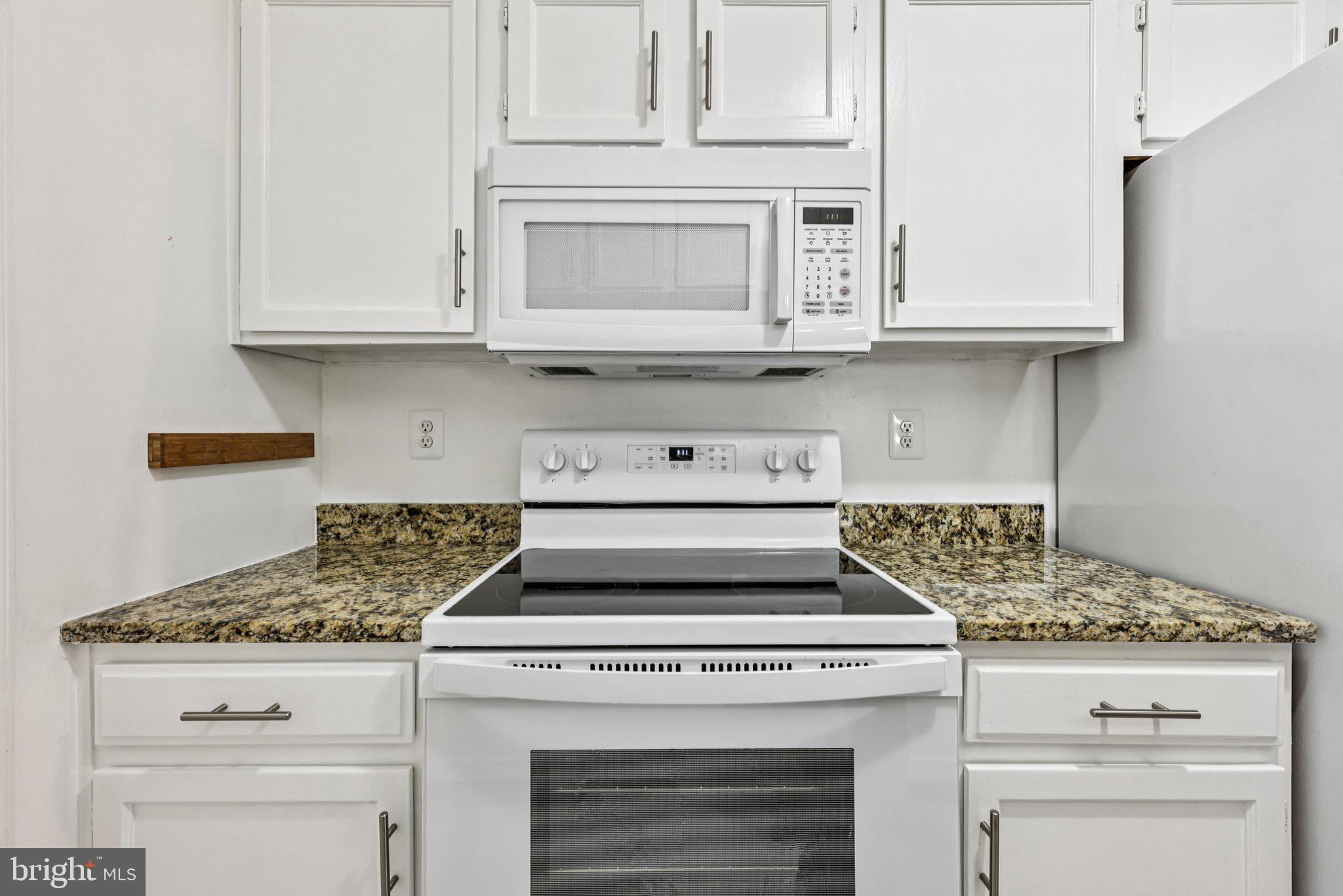 5707 Olde Mill Court, Unit 111 Alexandria, VA 22309 - Photo 12 of 32 a stove top oven sitting inside of a kitchen