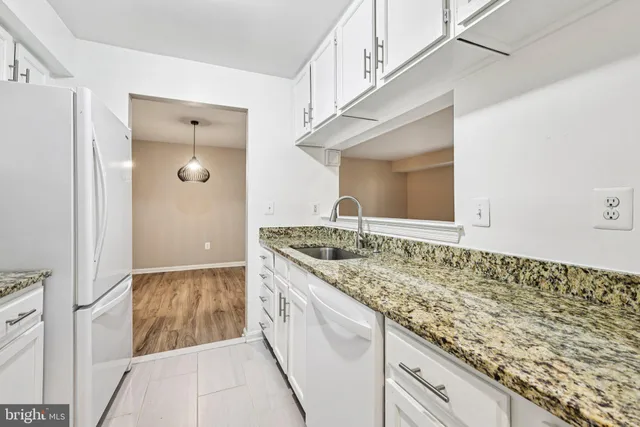 a bathroom with a granite countertop sink and mirror