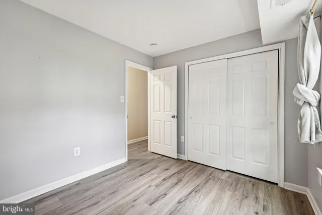 a view of an empty room and wooden floor