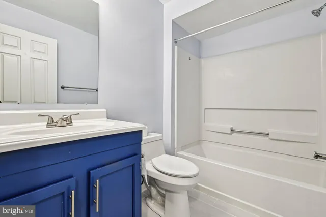 a bathroom with a sink vanity mirror and toilet