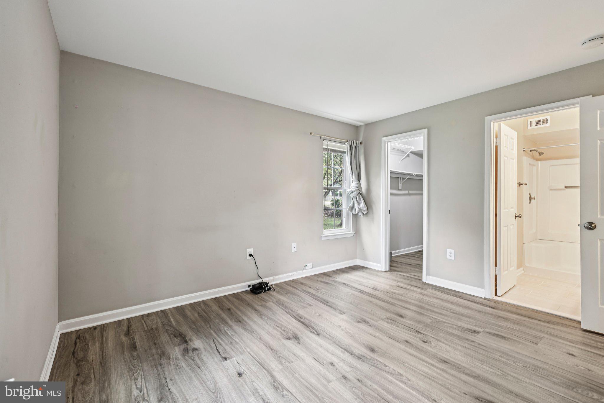 5707 Olde Mill Court, Unit 111 Alexandria, VA 22309 - Photo 19 of 32 an empty room with wooden floor and windows