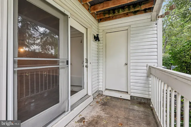a view of a door with wooden floor and a window